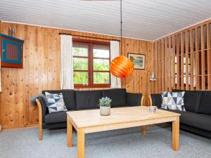 a living room with two couches and a coffee table at 4 person holiday home in Toftlund in Toftlund