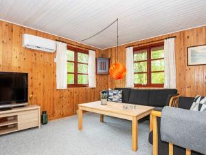 a living room with a couch and a table at 4 person holiday home in Toftlund in Toftlund
