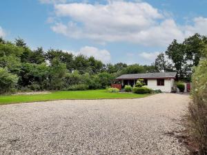 a gravel driveway leading to a white house at 4 person holiday home in Toftlund in Toftlund