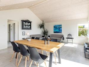 a dining room with a wooden table and chairs at Holiday home Skårup Fyn II in Mægård