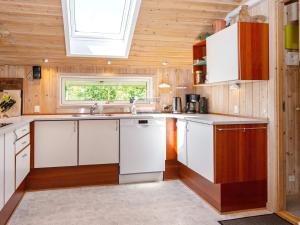 レムにある10 person holiday home in Skjernの白いキャビネットと窓付きのキッチン