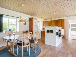 a kitchen and dining room with a table and chairs at Holiday home Nørre Nebel CXLII in Nørre Nebel