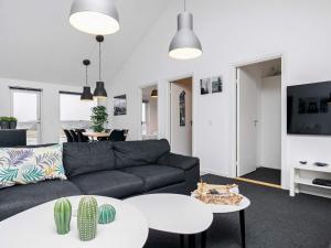 uma sala de estar com um sofá e uma mesa em 6 person holiday home in L kken em Lokken