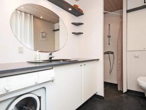 a bathroom with a washing machine and a mirror at 6 person holiday home in B rkop in Børkop