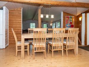 a dining room with a wooden table and chairs at Seaside Serenity at SkAdshoved-By Traum in Knebel +18 photos