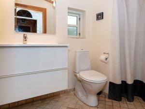 a white bathroom with a toilet and a sink at Holiday home Knebel V in Knebel