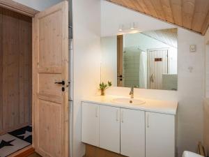 a bathroom with a sink and a mirror at 6 person holiday home in Ulfborg in Ulfborg +33 photos