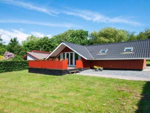 a small red house with a large yard at 6 person holiday home in Toftlund in Toftlund