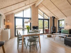 a kitchen and living room with a table and chairs at 8 person holiday home in Fanø in Fanø