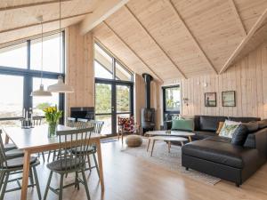a living room with a couch and a table at 8 person holiday home in Fanø in Fanø