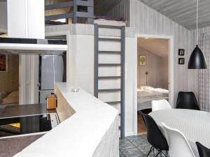 a kitchen and dining room with a loft bed at Four-Bedroom Holiday home in Glesborg 2 in Glesborg