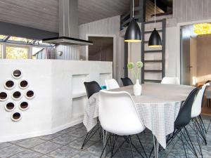 a dining room with a table and chairs at Four-Bedroom Holiday home in Glesborg 2 in Glesborg