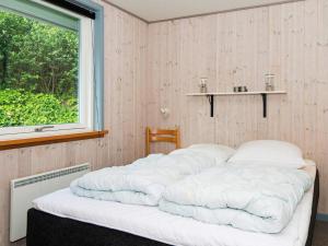 a bed in a room with a window at 6 person holiday home in B rkop in Egeskov