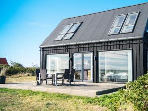 Struerにある5 person holiday home in Struerのテーブルと椅子が前にある家