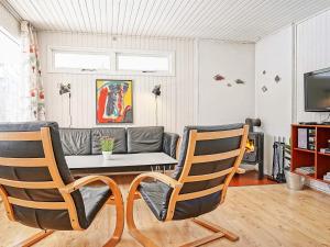a living room with a couch and two chairs at 4 person holiday home in Aakirkeby in Vester Sømarken