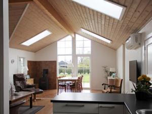 a kitchen and dining room with skylight ceilings and a dining table at Holiday home Esbjerg V XVII in Esbjerg