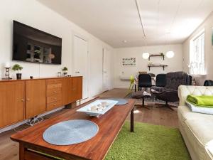 a living room with a couch and a table at 6 person holiday home in S by r in Søby