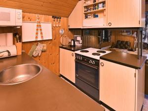 a kitchen with a stove and a sink at 6 person holiday home in N rre Nebel in Nørre Nebel