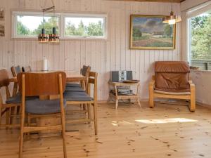 a dining room with a table and chairs at 7 person holiday home in Knebel in Knebel