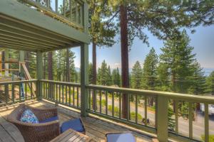 a deck with chairs and a view of the woods at Casa Azul in Incline Village