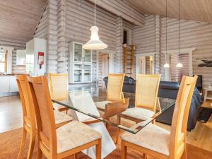 a dining room with a glass table and chairs at 8 person holiday home in Fr rup in Tårup