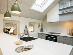 a kitchen with white counters and a white counter top at Holiday home Læsø VII in Læsø