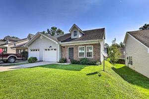 a house with a yard with a truck in front of it at Sleek Tallahassee Family Home - 5 Mi to Dtwn! in Tallahassee