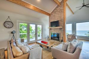 a living room with two couches and a fireplace at Tranquil Port Republic Home with Water Views! in Prince Frederick