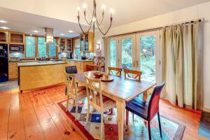 a kitchen and dining room with a wooden table and chairs at Azure Abode in Warren