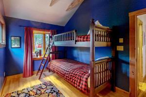 a bedroom with two bunk beds and blue walls at Azure Abode in Warren