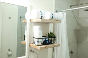 uma casa de banho com uma prateleira com toalhas e um espelho em Recently Renovated Apartment The Heart Of Flores em Flores