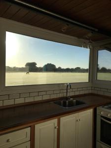 a kitchen with a sink and a large window at Tiny House, La Candelaria in Luján
