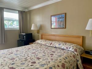 Postel nebo postele na pokoji v ubytování Greybull Motel