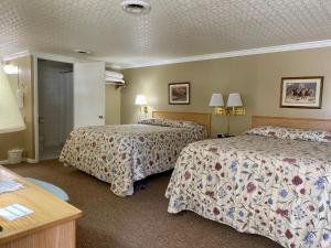 Postel nebo postele na pokoji v ubytování Greybull Motel
