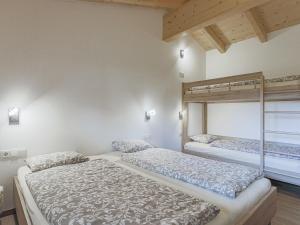 a bedroom with two beds and a window at Michelle Top 1 in Bramberg am Wildkogel