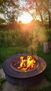 a fire pit in the middle of a yard at Rum Bridge 'Willows' Glamping Pod in Clare