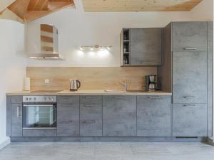 a kitchen with stainless steel cabinets and a stove at Michaela in Bramberg am Wildkogel