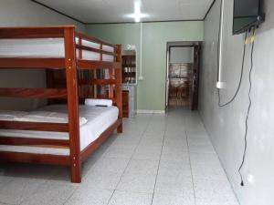 a room with two bunk beds and a television at Apartamento AMUEBLADO in Canoas