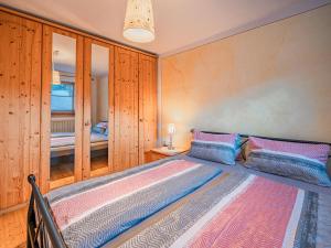 a bedroom with a bed with wooden walls at Haus Riedmann Christine in Hopfgarten im Brixental