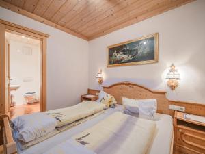 a bedroom with two beds and a painting on the wall at Weberhof Top 5 in Brixen im Thale