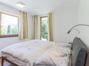 a bed in a room with a window at Chalet Jöchl in Sankt Johann in Tirol