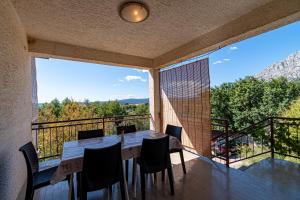 a dining room with a table and chairs on a balcony at Apartments with parking space Orebic, Peljesac - 10178 in Orebić