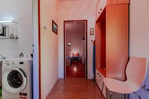 a bathroom with a washing machine in a room at Apartments with a parking space Orebic, Peljesac - 10178 in Orebić