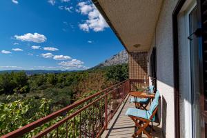 a balcony with a table and a view of the mountains at Apartments with a parking space Orebic, Peljesac - 10178 in Orebić