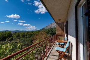 a balcony with a table and a view of the mountains at Apartments with parking space Orebic, Peljesac - 10178 in Orebić
