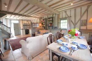 a dining room with a table and a living room at The Gig House, Stowupland in Stowmarket
