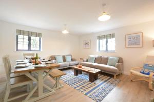 a living room with a couch and a table at Corner Cottage, Thorpeness in Thorpeness