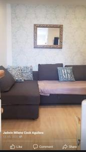 a couch in a living room with a mirror at Marahanata Jadwin 1Beautifull 1 Bedroom Flat in London