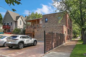a car parked in front of a brick house at 2BR Apartment close to Local Cafes & Stores - Magnolia G in Chicago