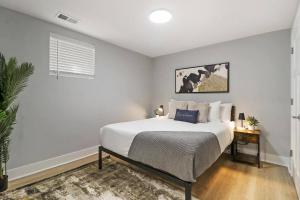 a white bedroom with a bed and a table at 2BR Apartment close to Local Cafes & Stores - Magnolia G in Chicago